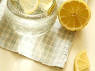 Glass of water with lemon on a stone table